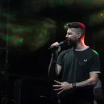 Pure Genius lead singer performing live on stage