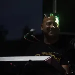 Pure Genius keyboardist performing at an outdoor evening gig