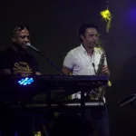 Pure Genius keyboardist and saxophonist performing together on stage
