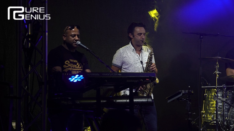 Pure Genius keyboardist and saxophonist performing together on stage